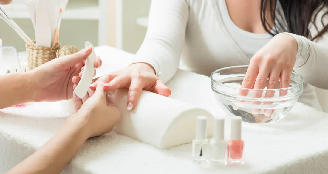 Manicure — nail filing at the table