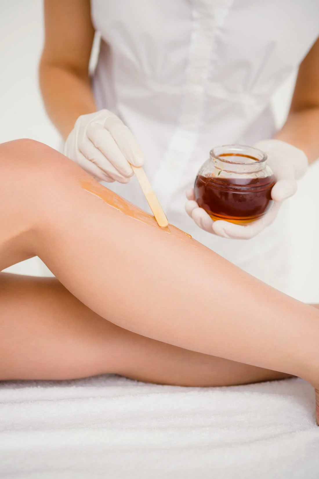 Waxing — warm honey wax and spatula